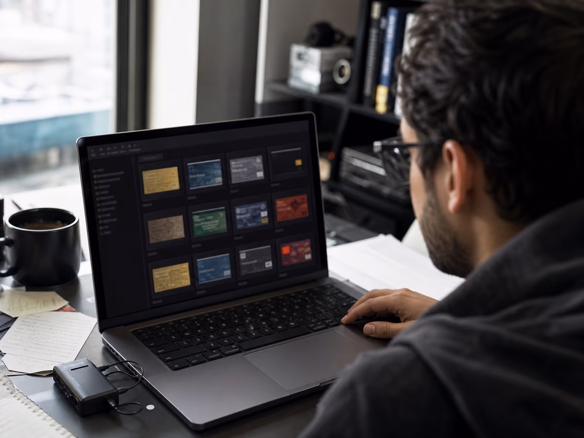 A cybersecurity researcher examines dark web credit card sites on a laptop in a modern office environment.